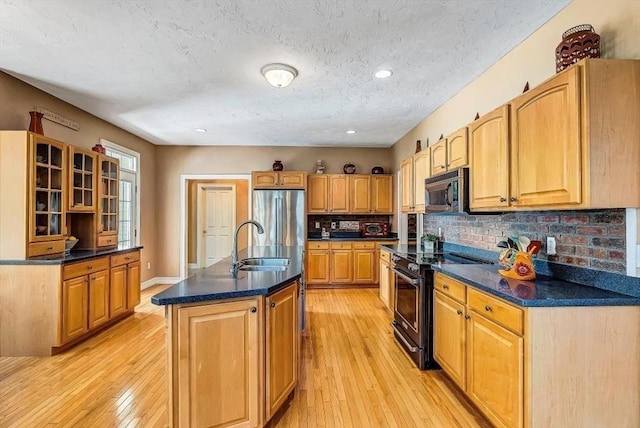 kitchen with black electric range, light wood-style flooring, dark countertops, a textured ceiling, and recessed lighting