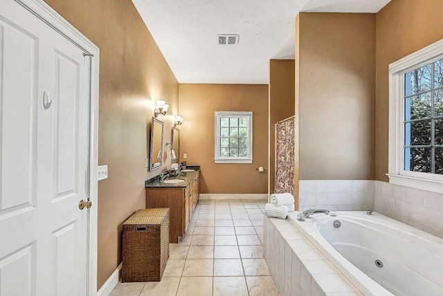 full bathroom with plenty of natural light, a jetted tub, vanity, and baseboards