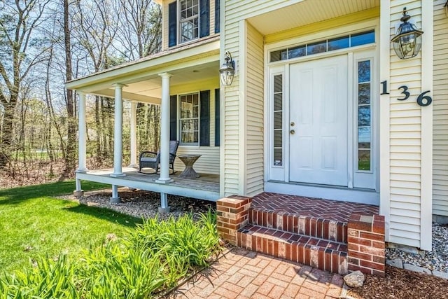view of exterior entry with covered porch