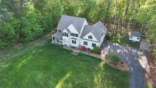 aerial view of property and surrounding area featuring a forest