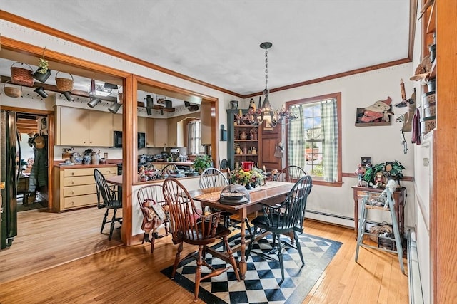 1 Pine Ln, Warren, RI 02885 - dining area featuring a chandelier, ornamental molding, a baseboard heating unit, and light wood-style floors