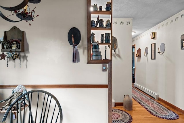1 Pine Ln, Warren, RI 02885 - hallway with baseboard heating, wood finished floors, and baseboards
