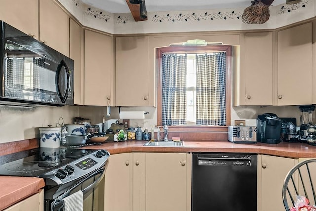 1 Pine Ln, Warren, RI 02885 - kitchen featuring black appliances, a sink, light countertops, and cream cabinetry