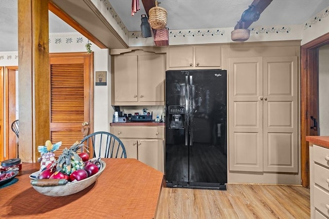 1 Pine Ln, Warren, RI 02885 - kitchen featuring black fridge with ice dispenser, light wood finished floors, and cream cabinetry