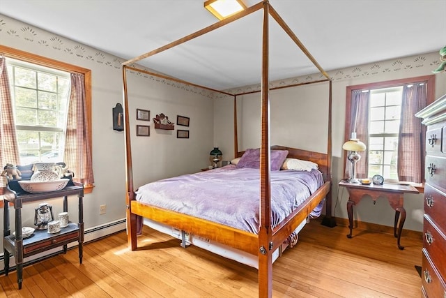 1 Pine Ln, Warren, RI 02885 - bedroom featuring light wood-style floors, multiple windows, baseboards, and a baseboard radiator
