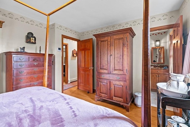 1 Pine Ln, Warren, RI 02885 - bedroom with light wood-style flooring and a baseboard heating unit