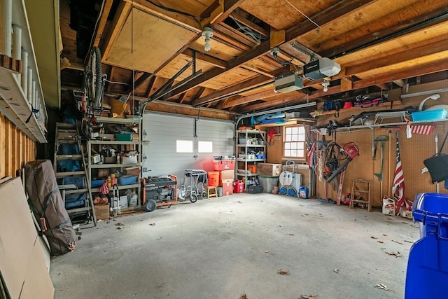 1 Pine Ln, Warren, RI 02885 - garage with a garage door opener and a workshop area