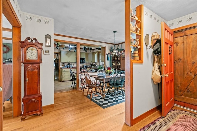 1 Pine Ln, Warren, RI 02885 - corridor with light wood-type flooring, baseboards, and a chandelier