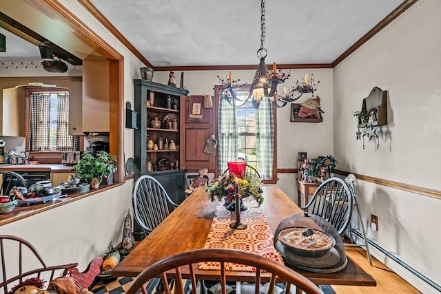 1 Pine Ln, Warren, RI 02885 - dining room with a chandelier, ornamental molding, wood finished floors, and a baseboard heating unit