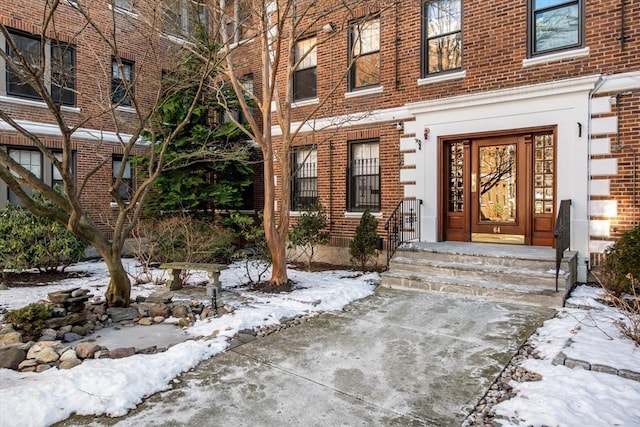 view of snow covered property entrance