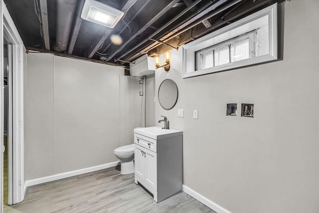 bathroom featuring vanity, toilet, and hardwood / wood-style floors