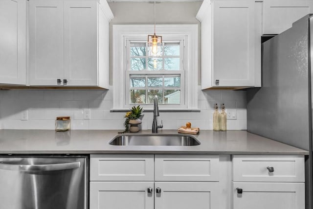 kitchen with sink, dishwasher, and white cabinetry