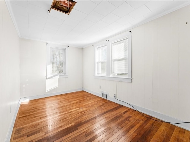 spare room with hardwood / wood-style floors and ornamental molding