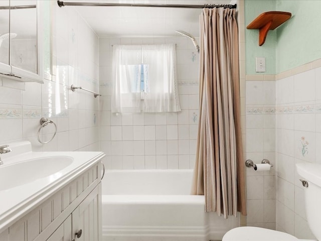 full bathroom with vanity, toilet, shower / bathtub combination with curtain, and tile walls