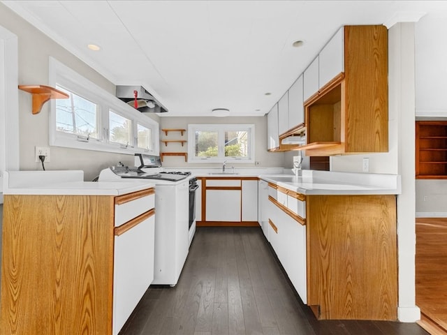 kitchen featuring white cabinets, dark hardwood / wood-style floors, washer / dryer, and white electric range oven