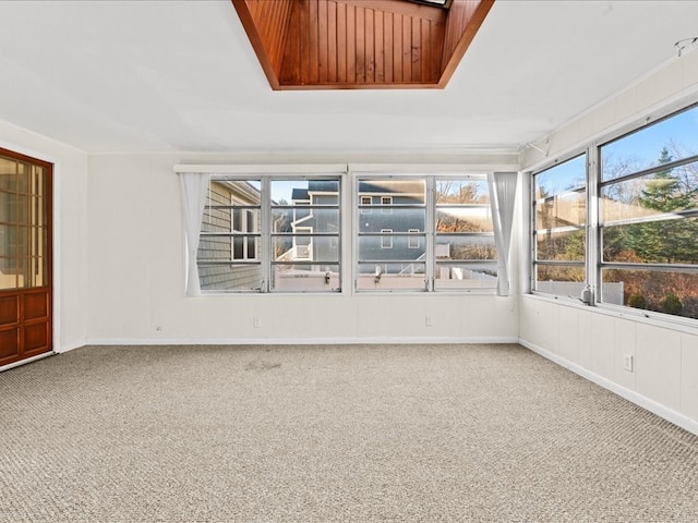 unfurnished sunroom featuring a skylight