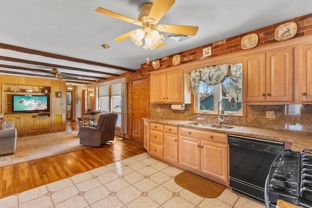 kitchen featuring ceiling fan, a sink, black dishwasher, beamed ceiling, and open floor plan