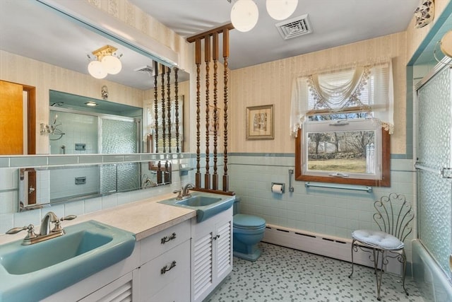 full bath featuring a sink, visible vents, a shower with door, and wallpapered walls