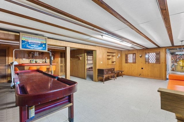 game room with tile patterned floors, beam ceiling, and wood walls