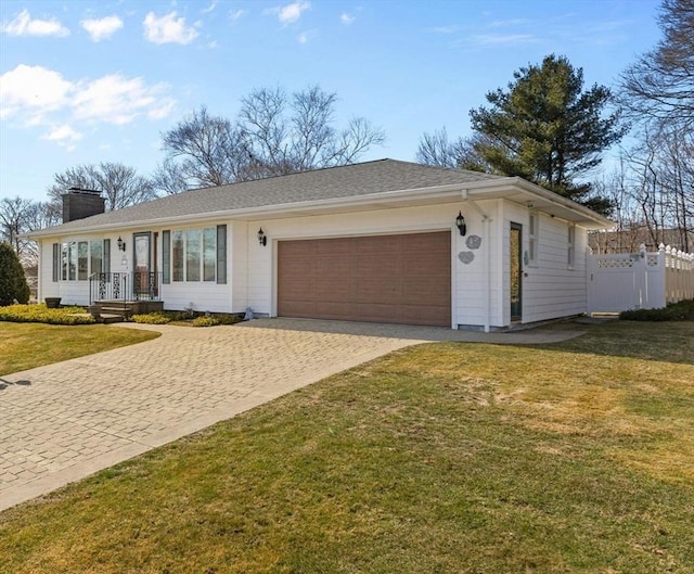 ranch-style home featuring a front lawn, fence, a garage, and a chimney