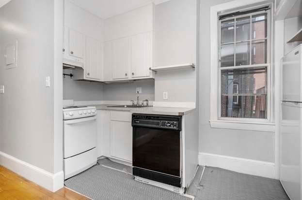 kitchen featuring white cabinets, sink, and white appliances