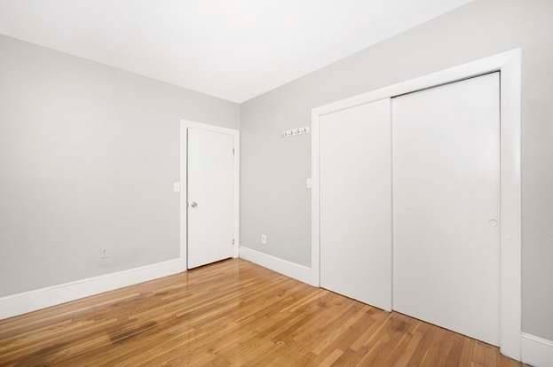 unfurnished bedroom with a closet and hardwood / wood-style floors