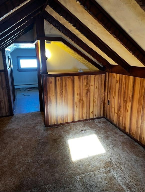 unfinished attic featuring a baseboard radiator