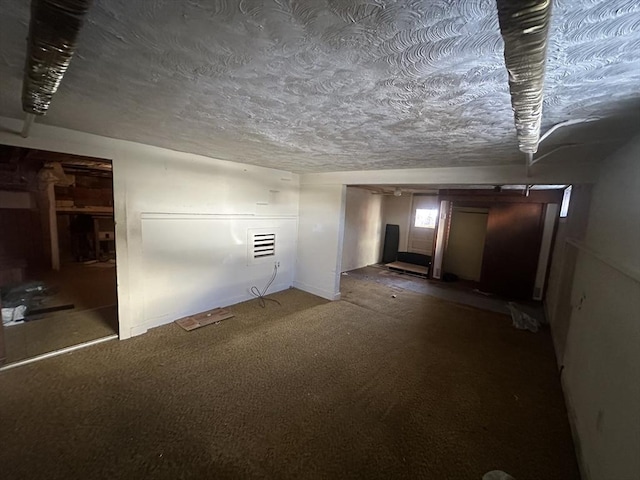 basement featuring a textured ceiling