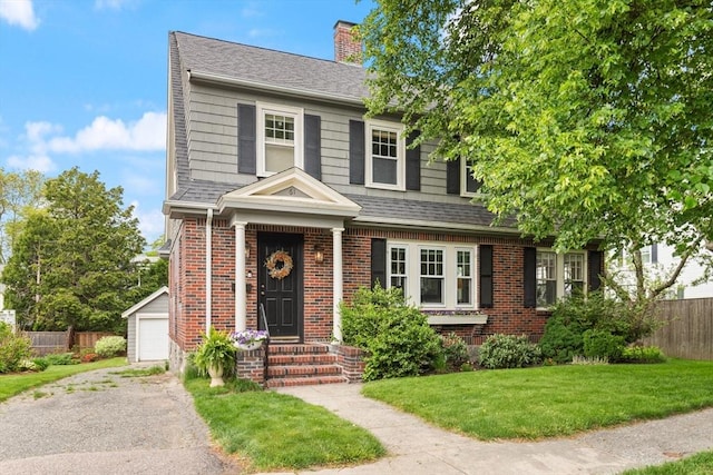 61 Howitt Rd, Boston, MA 02132 - view of front of house with a chimney, brick siding, a shingled roof, and a detached garage