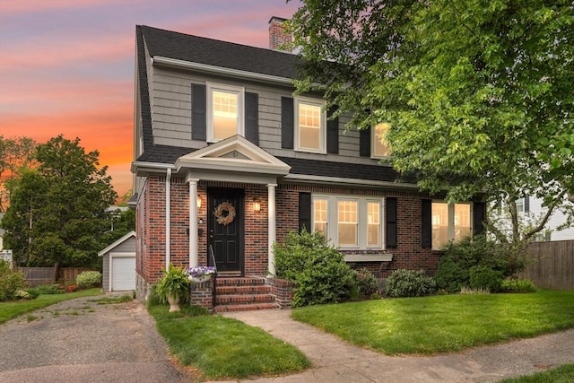 61 Howitt Rd, Boston, MA 02132 - view of front of home featuring a chimney, brick siding, an outdoor structure, a garage, and roof with shingles