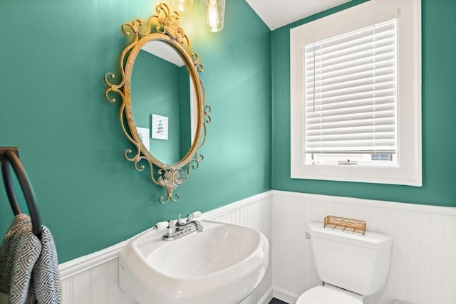 61 Howitt Rd, Boston, MA 02132 - bathroom with wainscoting, a sink, toilet, and a decorative wall