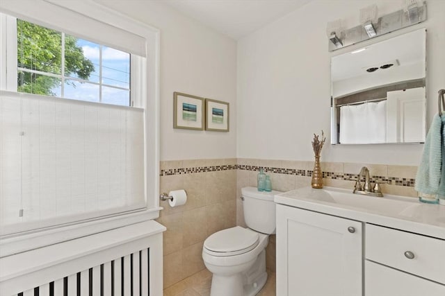 61 Howitt Rd, Boston, MA 02132 - bathroom with vanity, toilet, tile walls, wainscoting, and tile patterned flooring