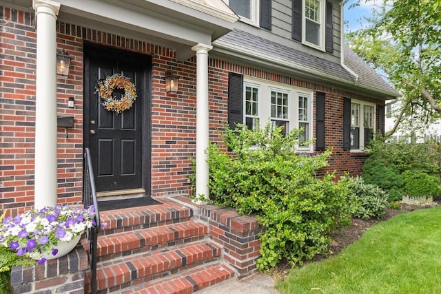 61 Howitt Rd, Boston, MA 02132 - view of exterior entry with brick siding and a shingled roof