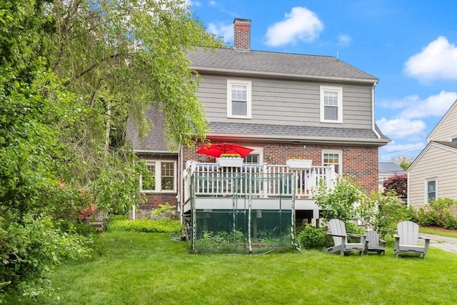 61 Howitt Rd, Boston, MA 02132 - back of property featuring brick siding, a yard, a deck, and a chimney