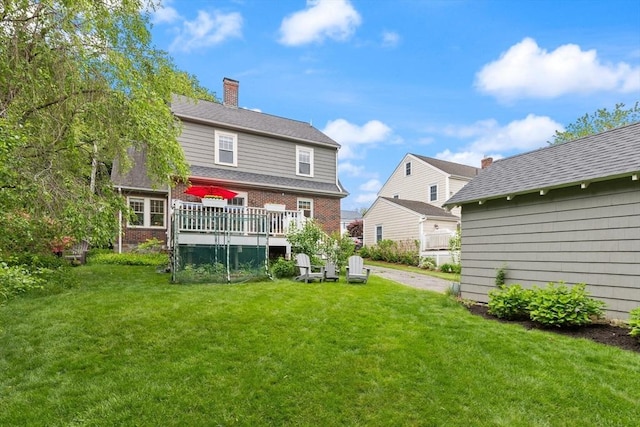 61 Howitt Rd, Boston, MA 02132 - rear view of property featuring a yard, a deck, a chimney, and brick siding