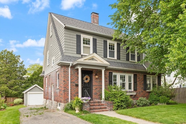 61 Howitt Rd, Boston, MA 02132 - view of front of property with an outdoor structure, asphalt driveway, a chimney, and brick siding
