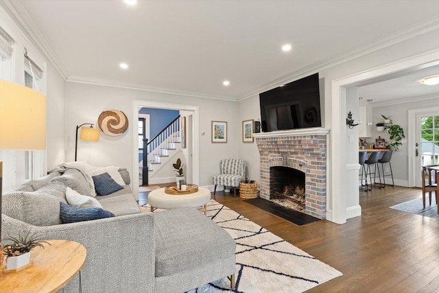 61 Howitt Rd, Boston, MA 02132 - living area with wood finished floors, stairs, a brick fireplace, crown molding, and recessed lighting