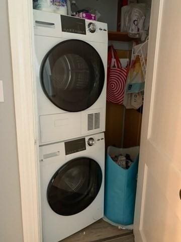 342 Commonwealth Ave Unit 2, Boston, MA 02115 - washroom with stacked washer and clothes dryer and wood finished floors