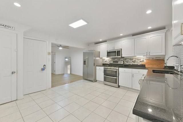 kitchen with white cabinetry, sink, ceiling fan, decorative backsplash, and appliances with stainless steel finishes