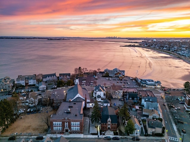 aerial view at dusk with a water view