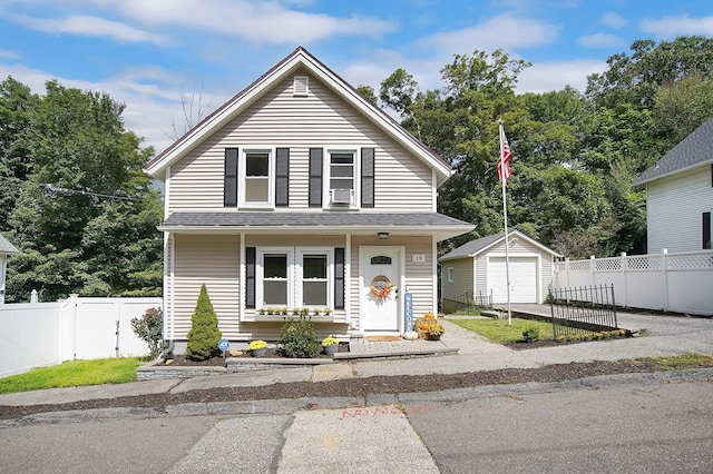 view of front of home featuring an outdoor structure, a garage, and cooling unit