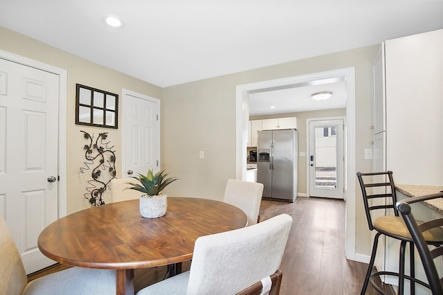 dining room with wood-type flooring