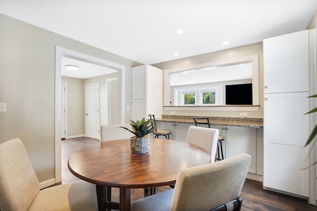 dining space with dark hardwood / wood-style flooring