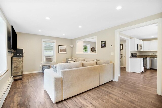 living room with a baseboard radiator and hardwood / wood-style flooring