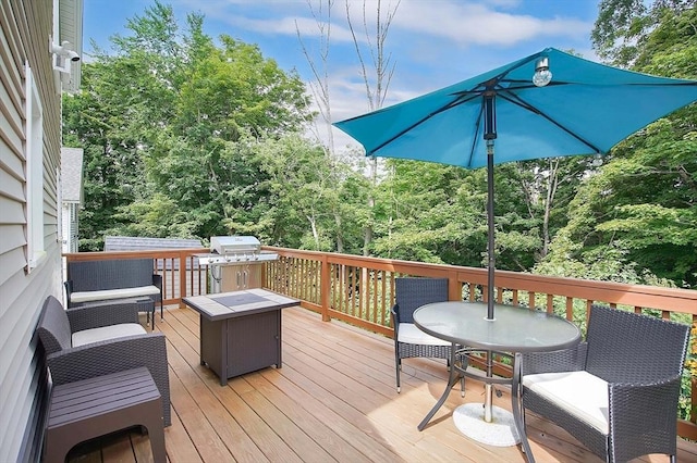 deck featuring grilling area and an outdoor living space with a fire pit