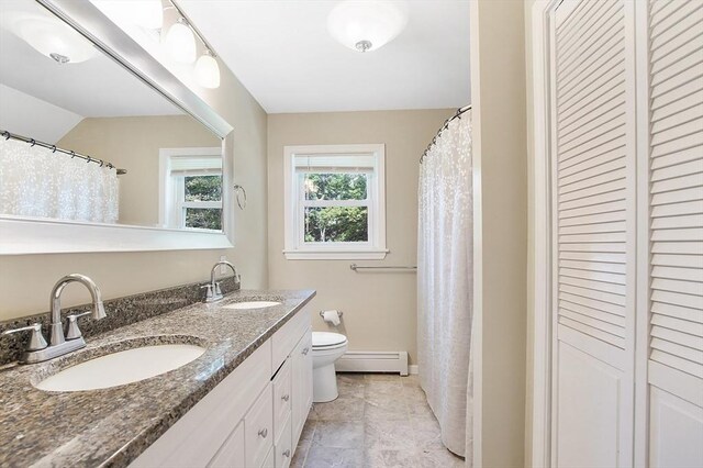 bathroom with tile patterned flooring, vanity, a baseboard heating unit, and toilet