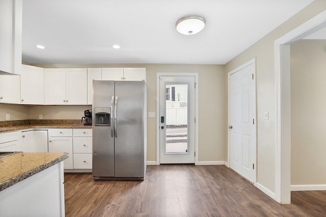 kitchen with stainless steel fridge with ice dispenser, wood-type flooring, dark stone counters, and white cabinets