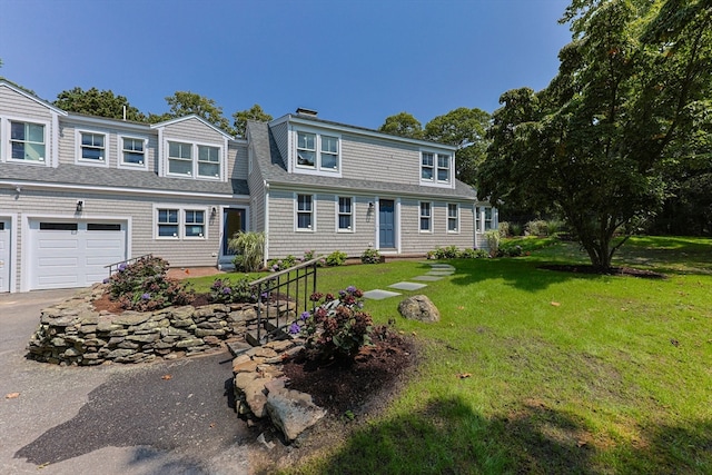 view of front of house featuring a garage and a front yard