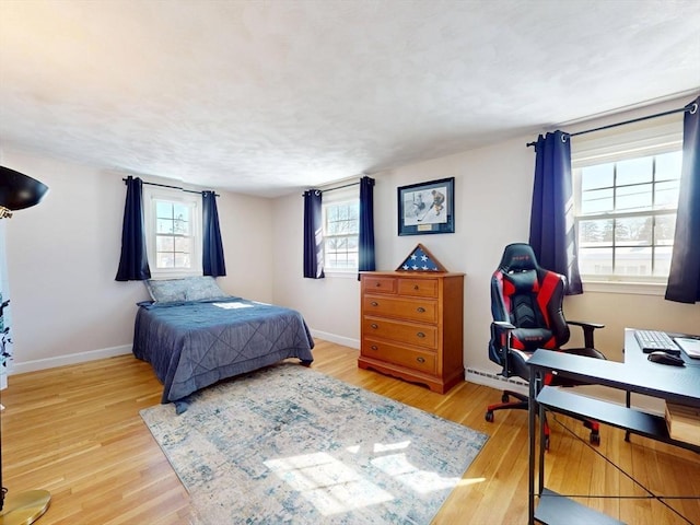 bedroom with wood finished floors and baseboards