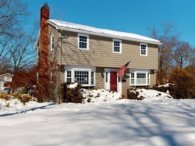 colonial house featuring a chimney